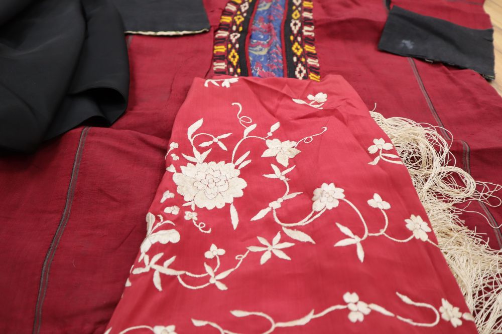 A black shawl with white embroidery, a smaller embroidered shawl, a kimono and a claret embroidered jacket